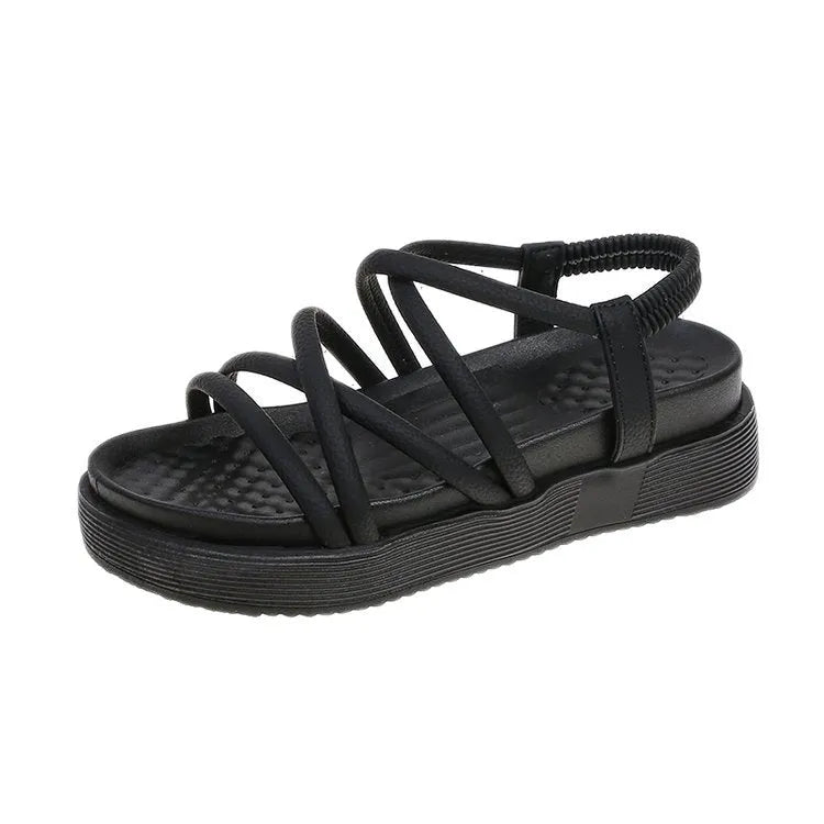 Women's black and beige Roman-style platform sandals with a round toe holder on a textured sole.