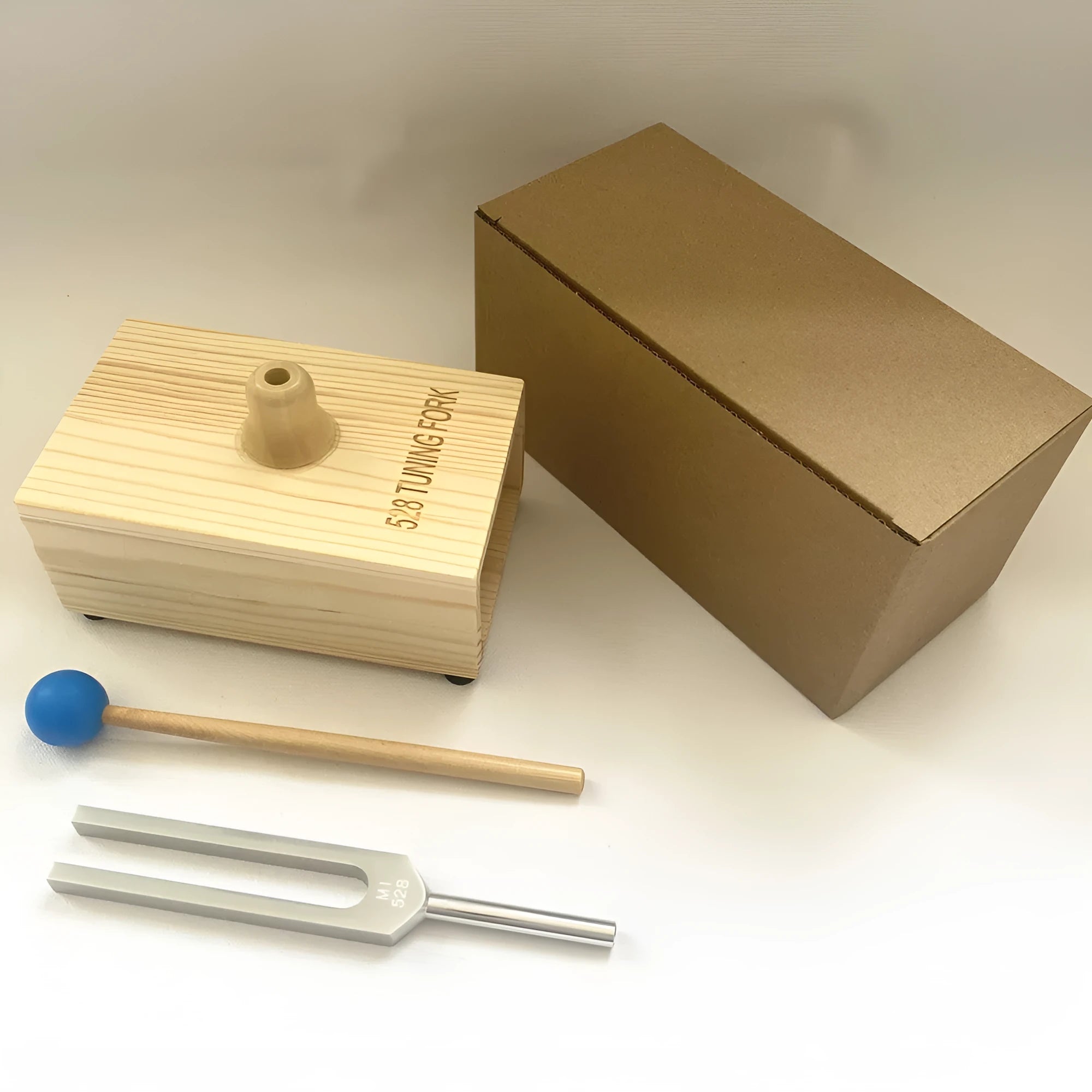 432Hz aluminium alloy tuning fork with speaker for sound therapy on kraft paper box
