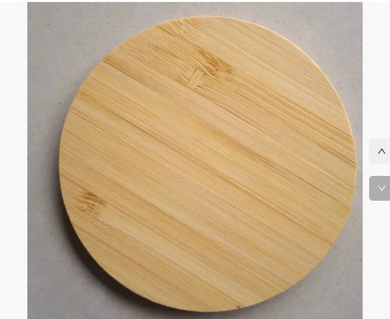 Square natural bamboo 5W QI wireless charging pad on a wooden surface.