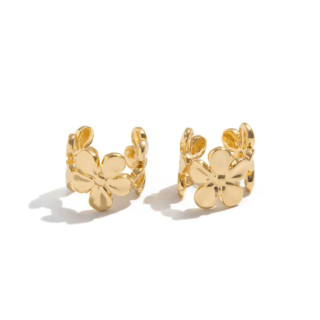 A pair of gold drop earrings featuring a detailed starfish and conch design on an alloy base.