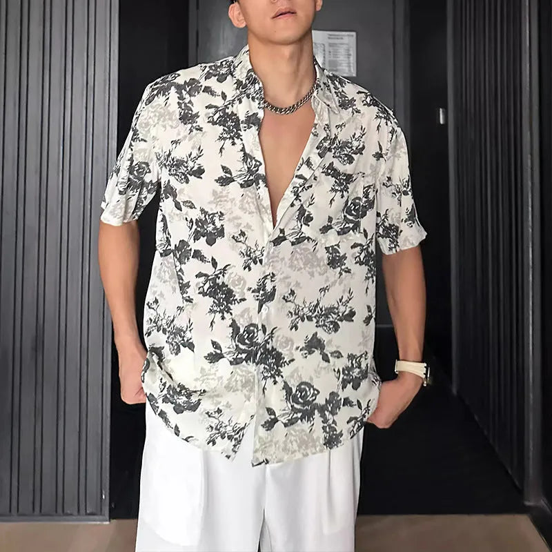 Men's loose-fit black short sleeve shirt with a white floral print pattern.