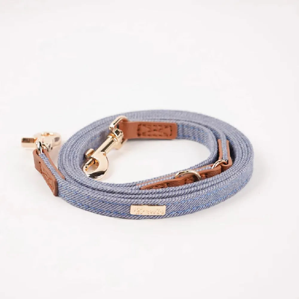 Adjustable mohair dog collar with nameplate and hand holding rope in cement gray