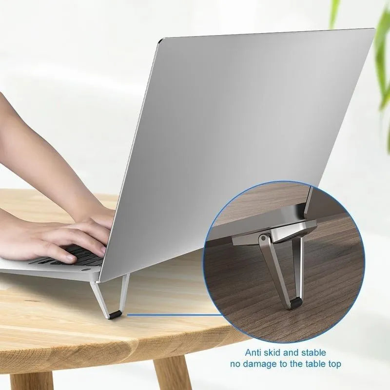 Foldable aluminium computer bracket shown in silver next to 3M adhesive strips for mounting