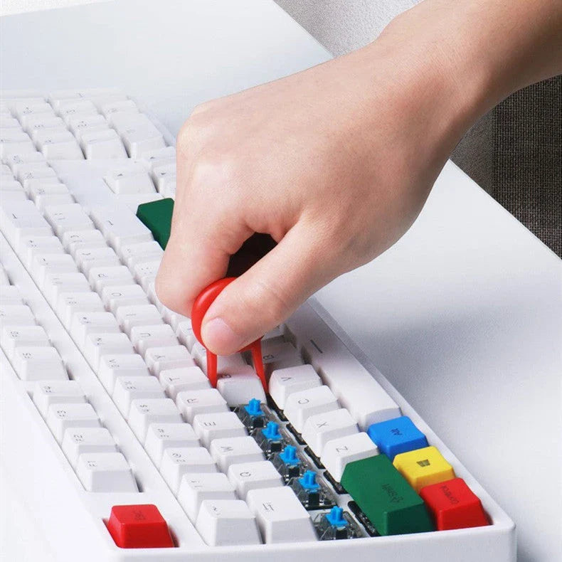 Versatile 4-in-1 keyboard cleaning brush with nylon bristles, flocking sponge, metal pen tip, and keycap puller for efficient cleaning of gaming equipment