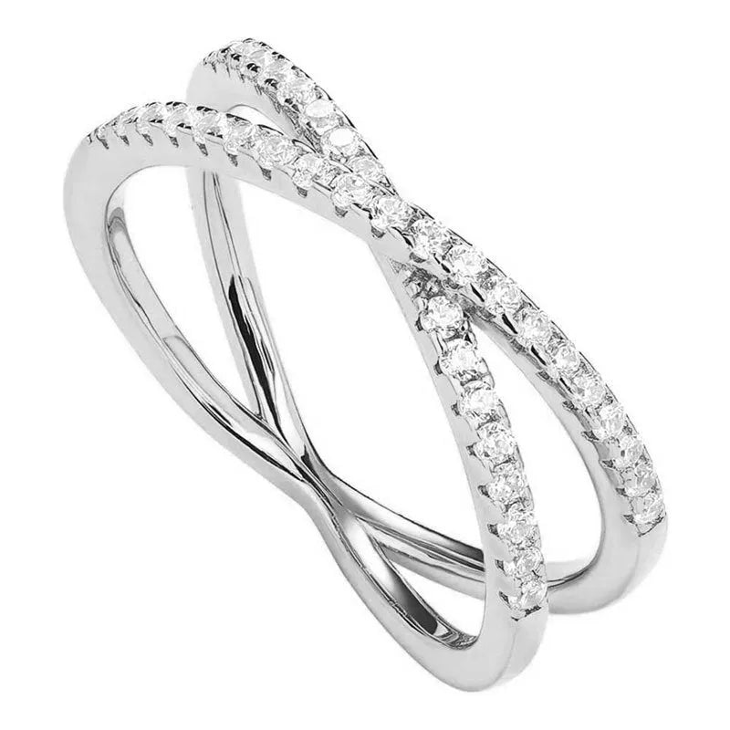 Silver cross ring with diamond accents in half circle wide band design on white background