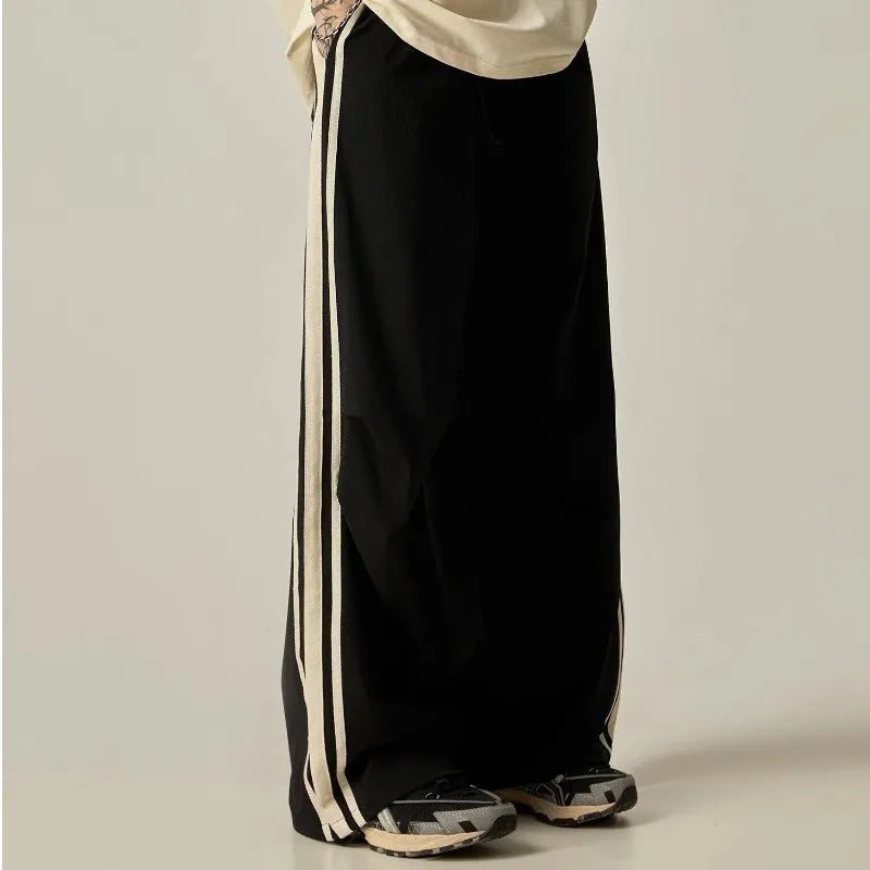 Black wide leg climbing pants for men showing high waist and straight leg design