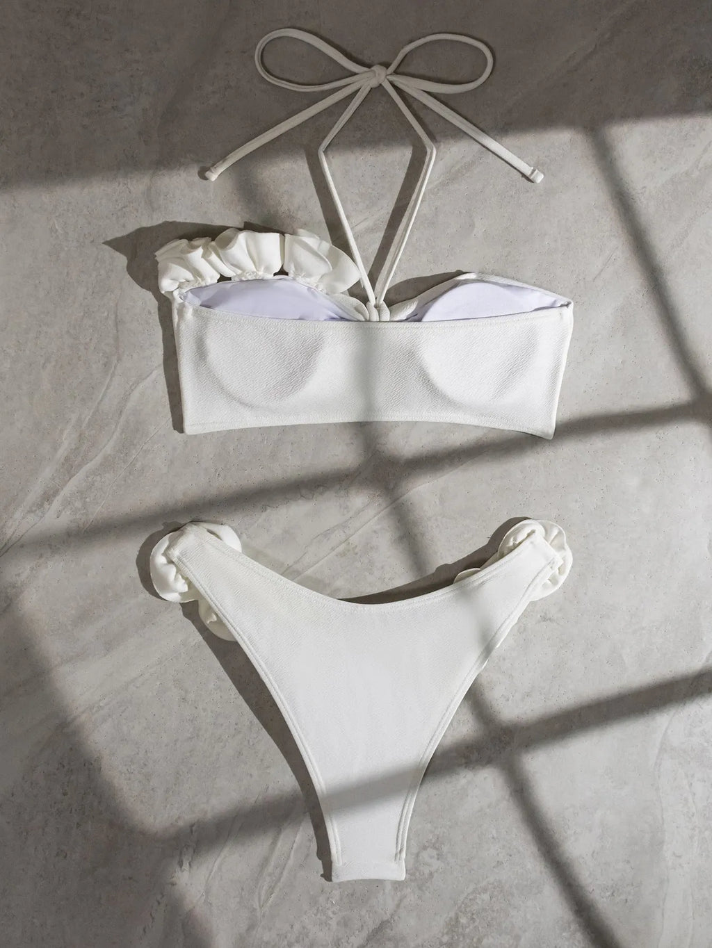 White halter neck bikini set with 3D flower design and lace-up back