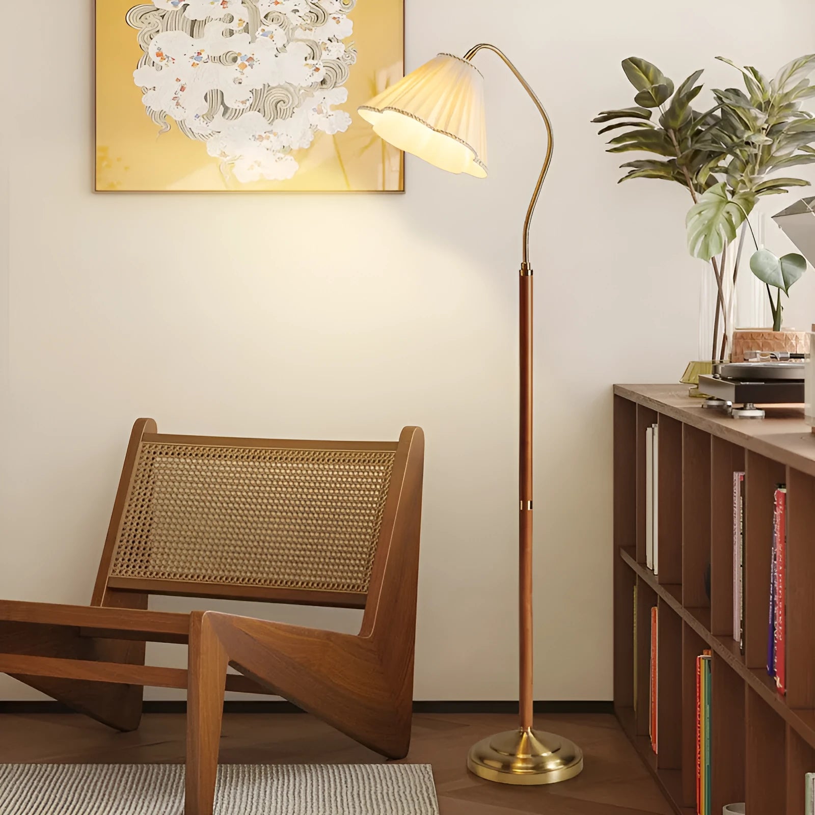 Solid wood floor lamp with fabric shade in walnut colour placed beside a sofa in a living room