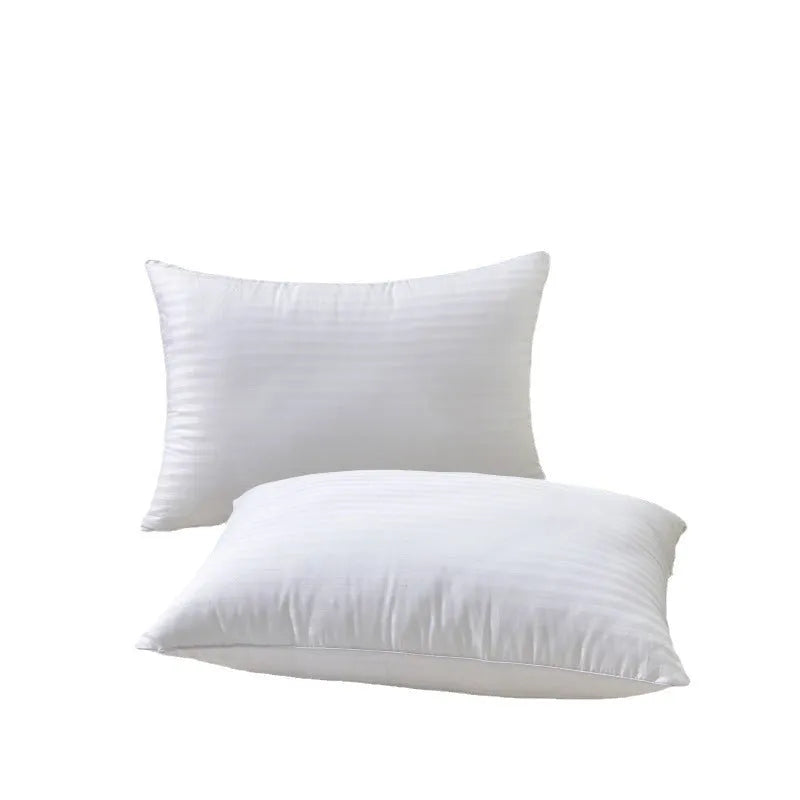 White cotton satin stripe feather and cotton pillow shown in a simple style on a bed.