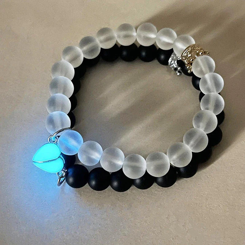 Luminous glow-in-the-dark crown bracelet set in white and black colors, showcasing a unique design and enchanting nighttime glow