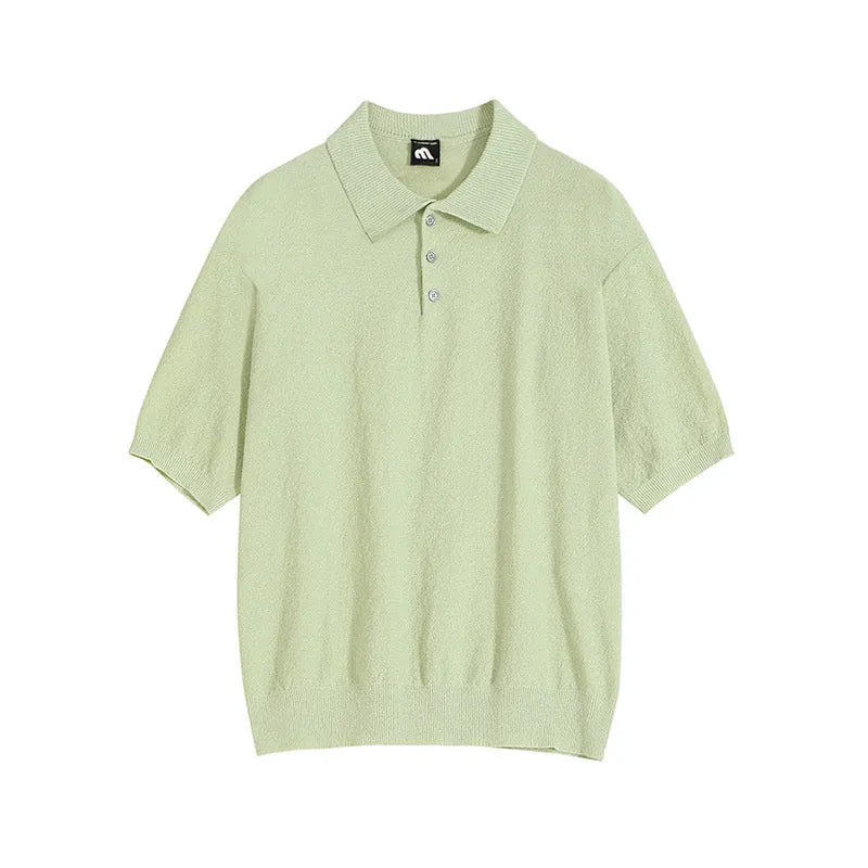 Man modelling a caramel coloured loose-fit knitted short sleeve polo shirt with an asymmetric design.