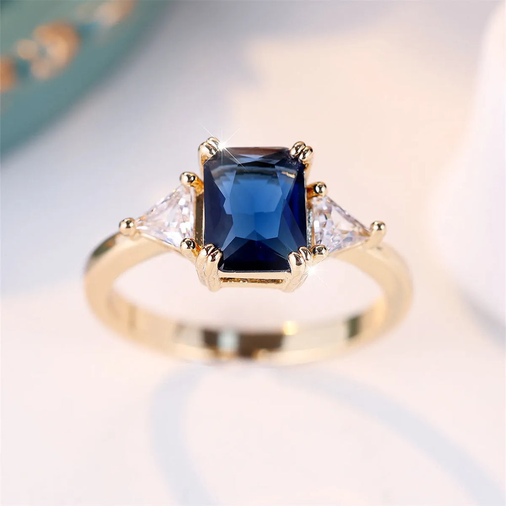 Rectangular copper ring with gold sapphire blue finish, shown on hand