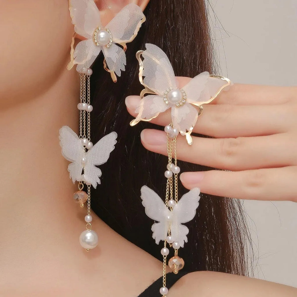 White butterfly earrings with lace tassel, pearl accents and rhinestones on copper alloy