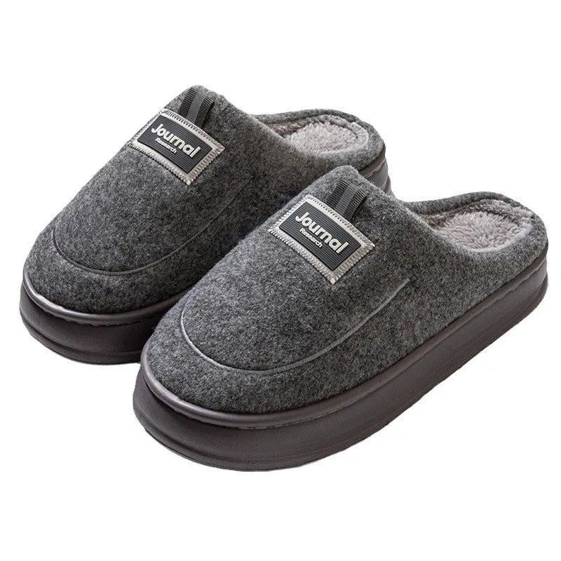 Men's brown suede slippers with a thickened design and textured EVA sole, shown on a wooden floor.