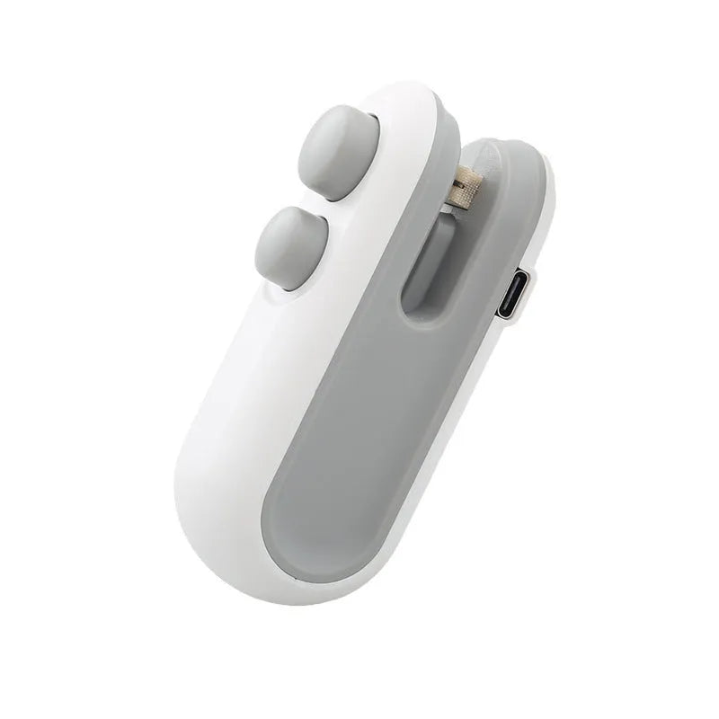 White handheld vacuum sealing machine with magnetic back and cutter blade for chip bags