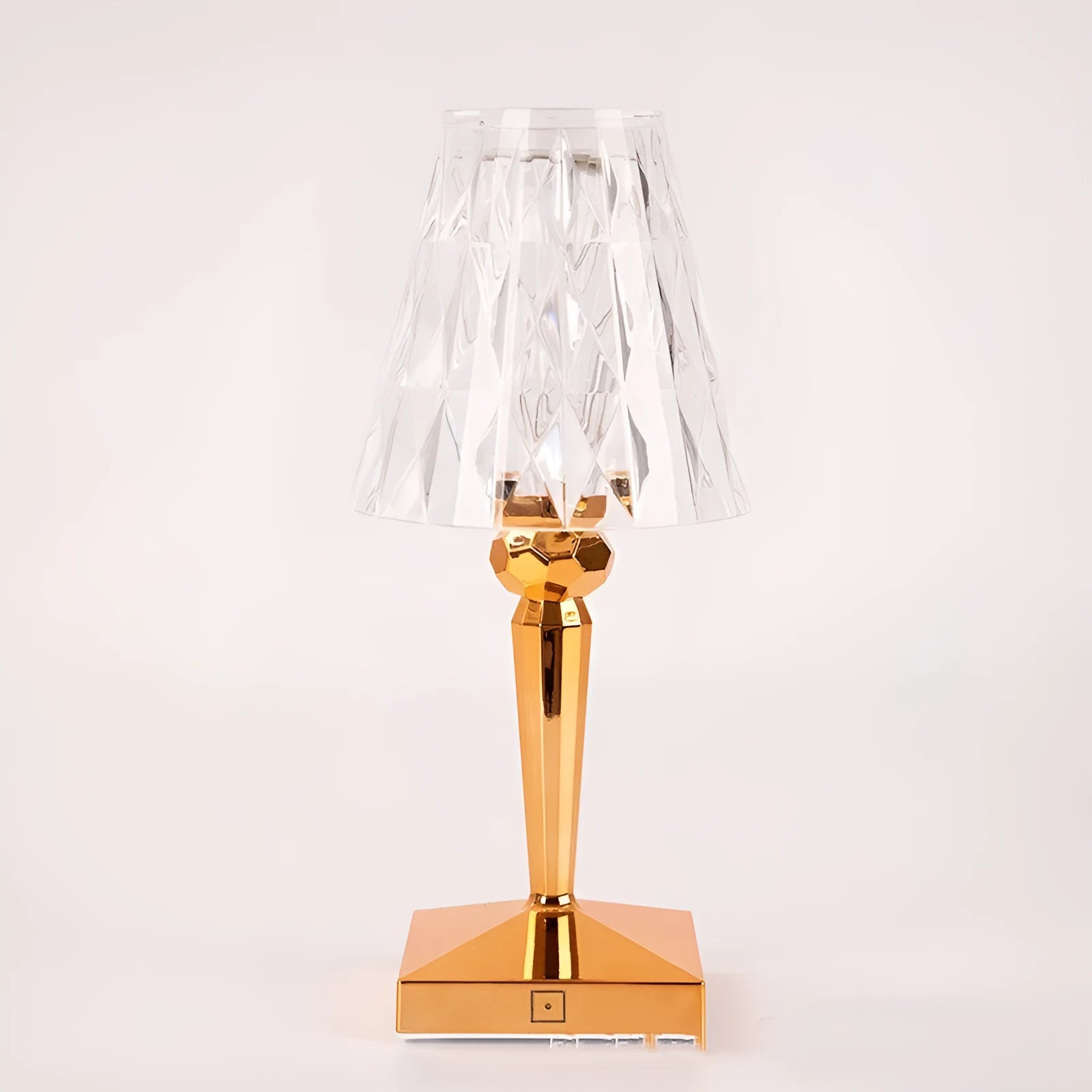 Rose gold portable touch control night light on a surface.