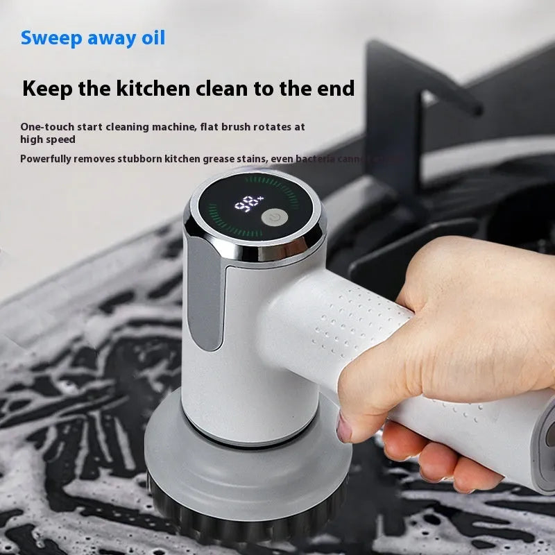 White cordless electric cleaning brush with interchangeable brush heads on a kitchen counter.