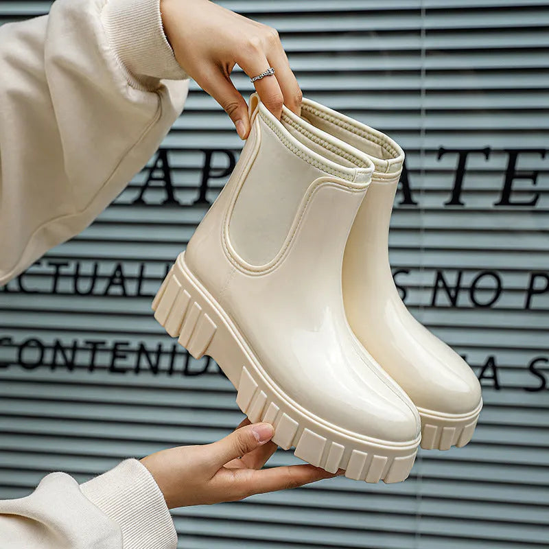 PVC low tube rain boot in solid colour with flat heel and non-slip sole.