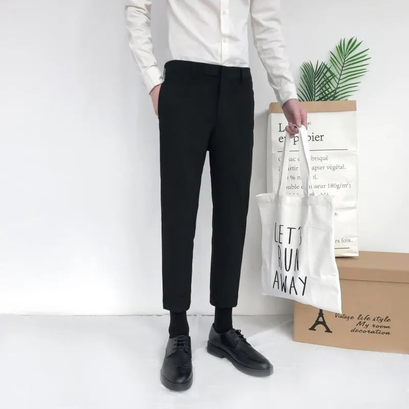 Men's slim straight-leg cotton trousers with a drawstring waist in black, shown front and side.