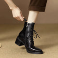 Women's black pointed-toe short tube boots with 5.5cm block heel on wooden floor