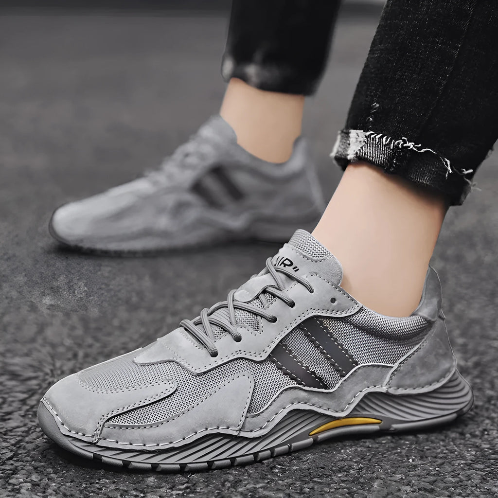 Men's low-top lace-up hiking boots in grey with pigskin upper and platform rubber sole.