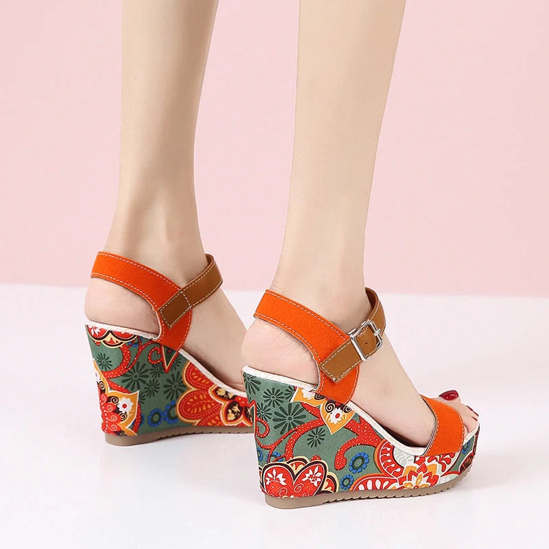Women's floral embroidered wedge sandals in black, green, and orange with buckle strap