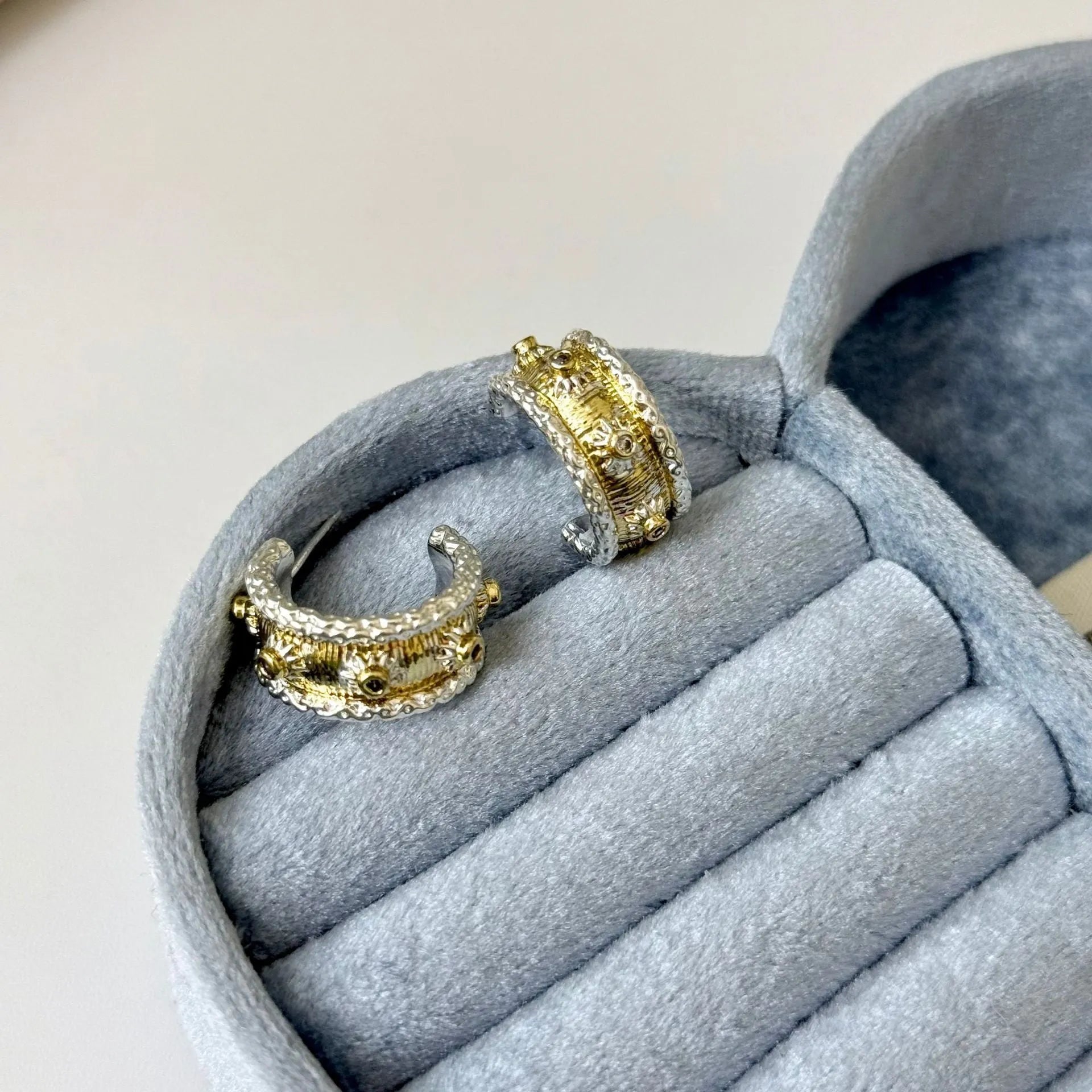 Gold and silver colour matching C-shaped brushed ring earrings with 925 silver needle on display