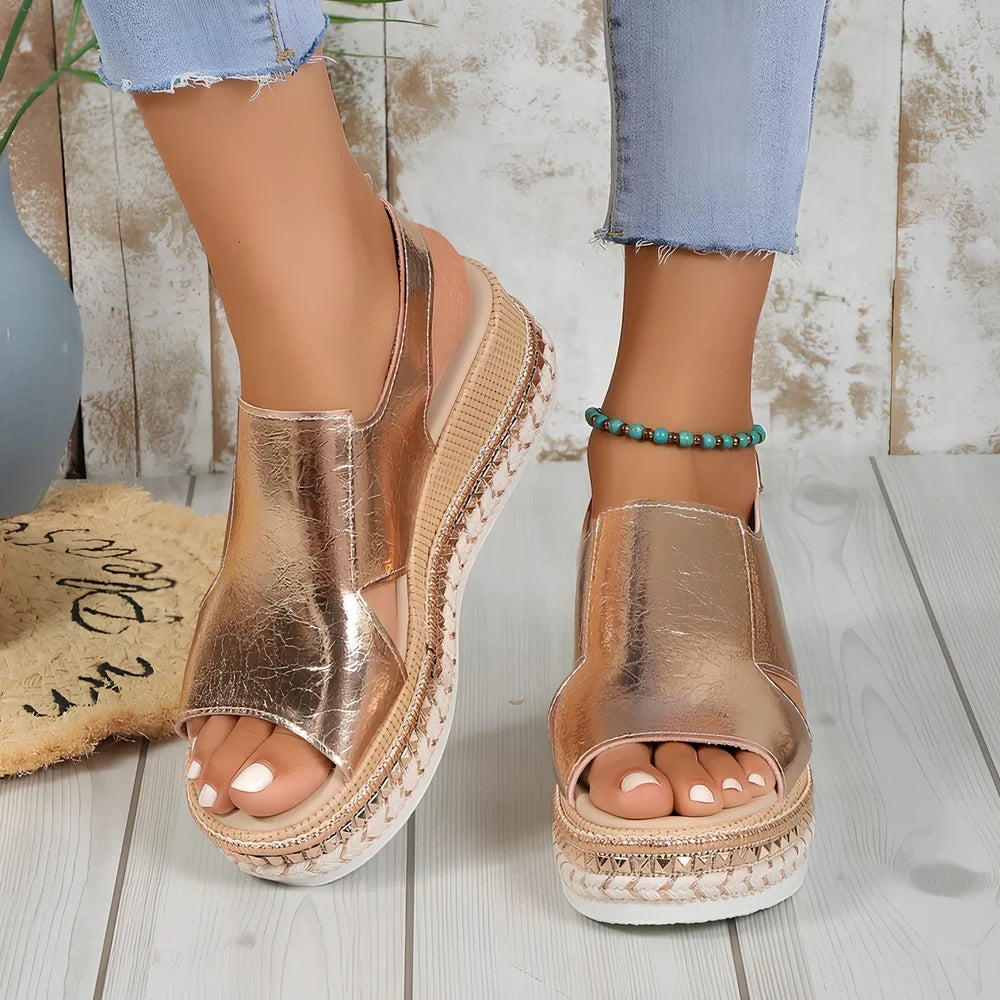 Women's gold fish mouth buckle wedges with hollow sides and 7 cm rubber heel on white background