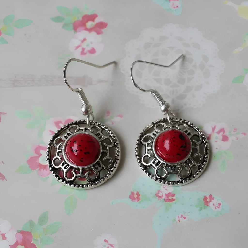 Handmade geometric flower disk earrings in Tibetan silver and turquoise with ethnic patterns.