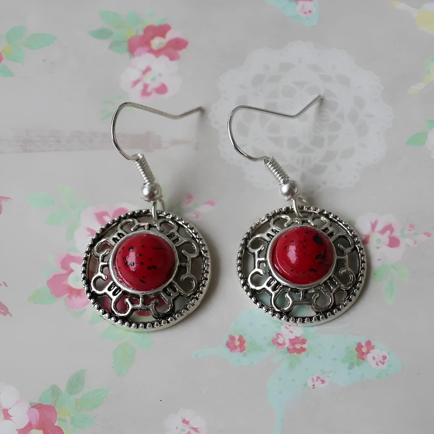 Handmade geometric flower disk earrings in Tibetan silver and turquoise with ethnic patterns.
