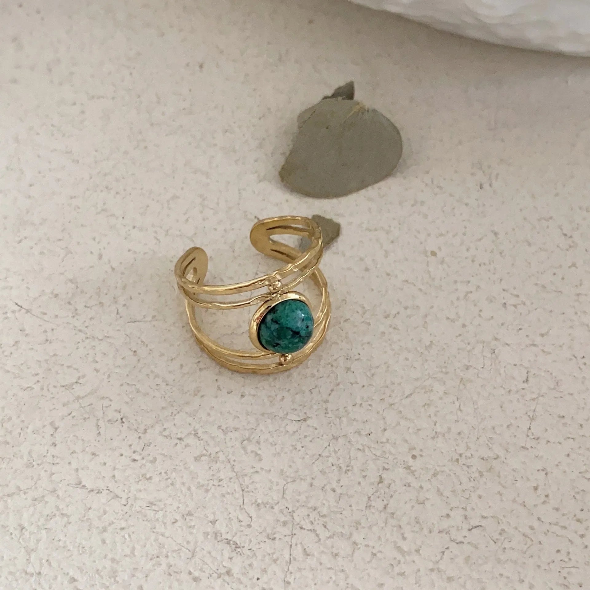 Titanium steel geometric open ring with natural green stone centrepiece on alloy band