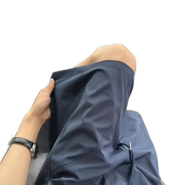 Men's quick-drying sports shorts in polyester fabric available in creamy-white, black and navy blue colours