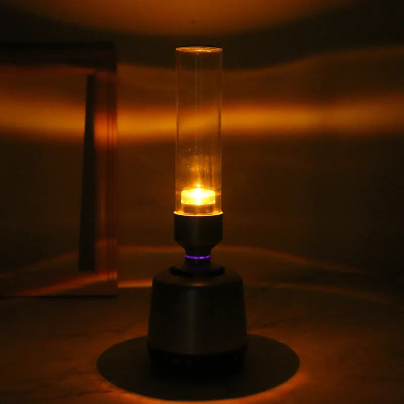 White silver cylindrical Bluetooth speaker and night light unit on a table.