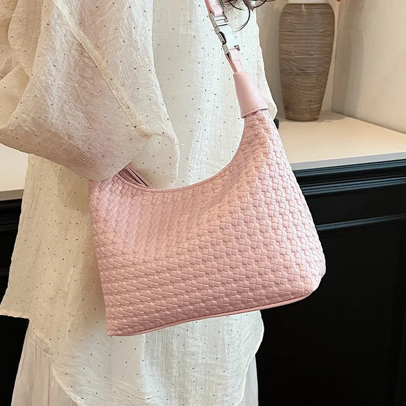 Soft beige PU bucket-shaped messenger bag with an external pocket, shown open to reveal internal document organiser.