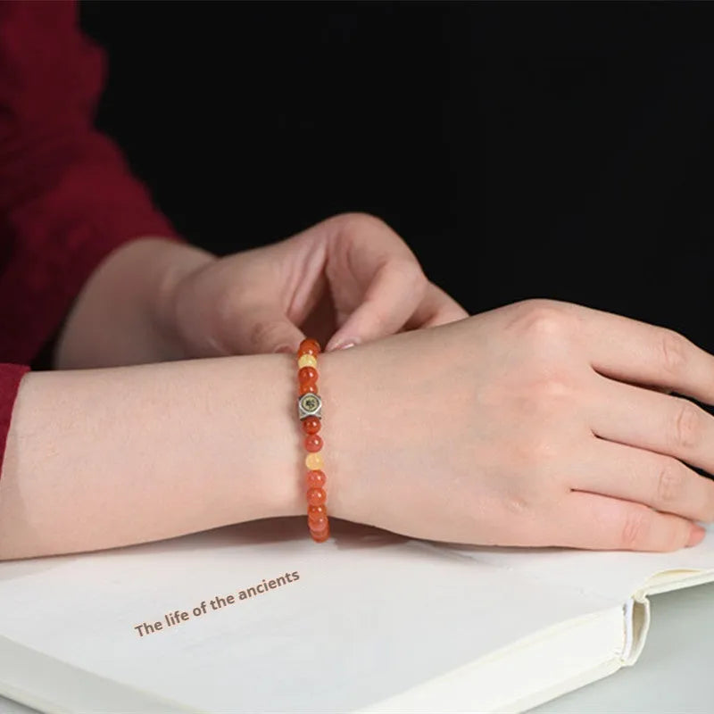 Natural red Nanhong agate and amber beeswax bead bracelet on a string, with zodiac constellation design.