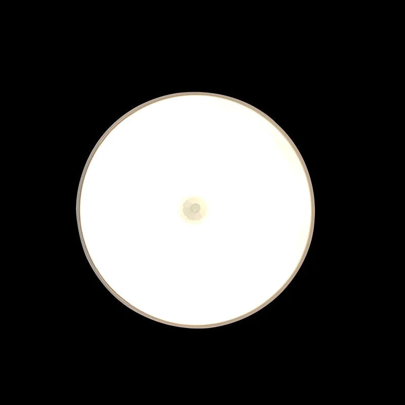 Round small night lamp with side push key, 86mm diameter, white housing, glowing warm light on a wooden nightstand