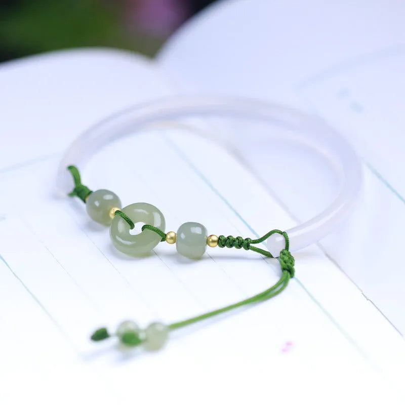 Hand-woven half bracelet with white agate and hetian jade beads and a peace buckle.
