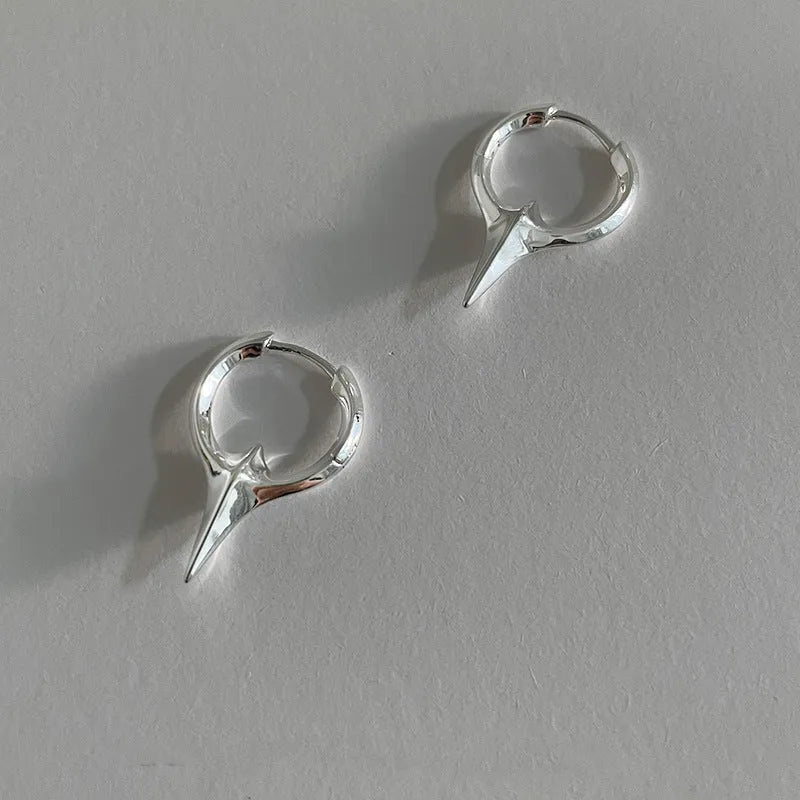 Gold plated geometric star earrings with copper construction and XINGX ear clip design