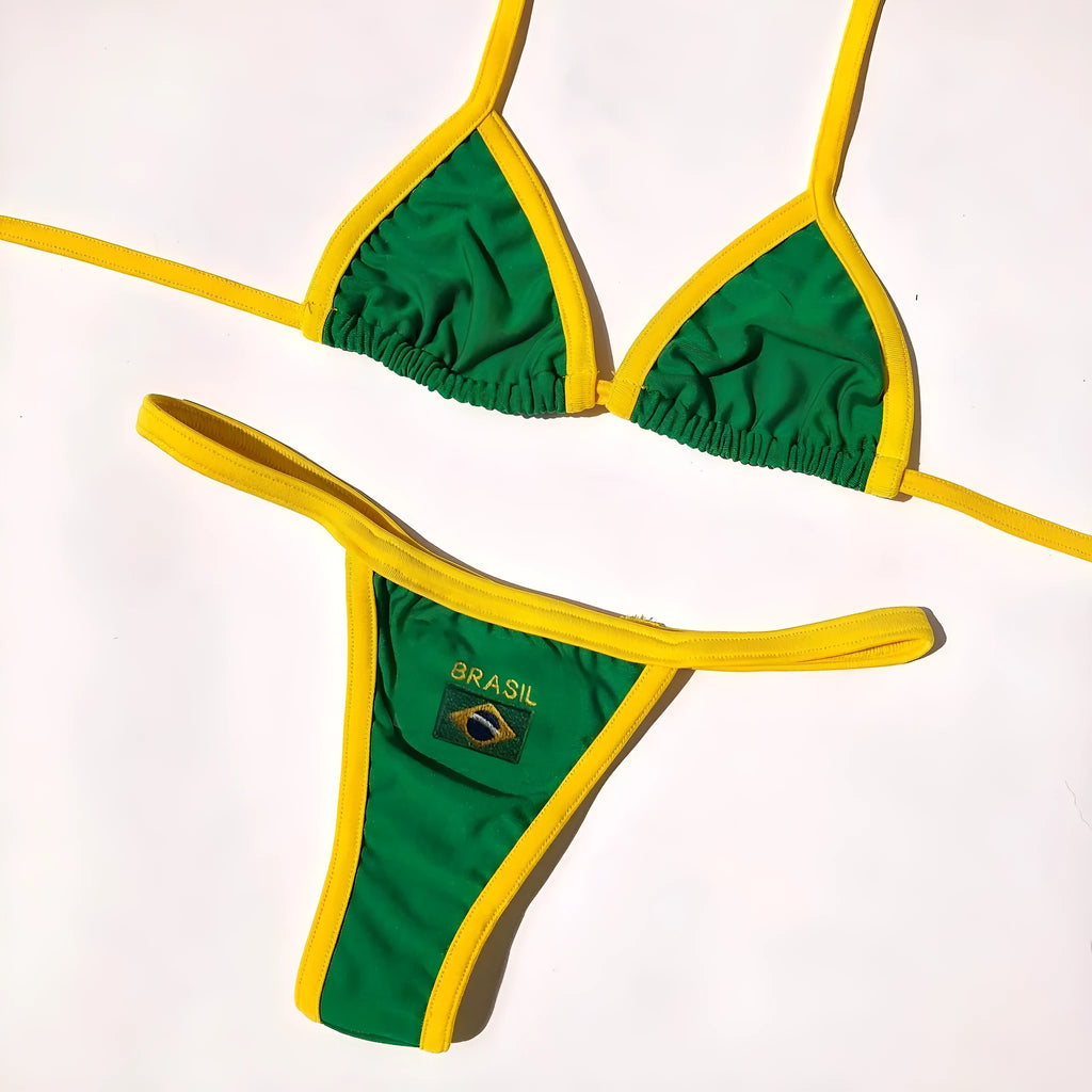 Women's yellow polyester T-back bikini with shorts-length pants on a beach background