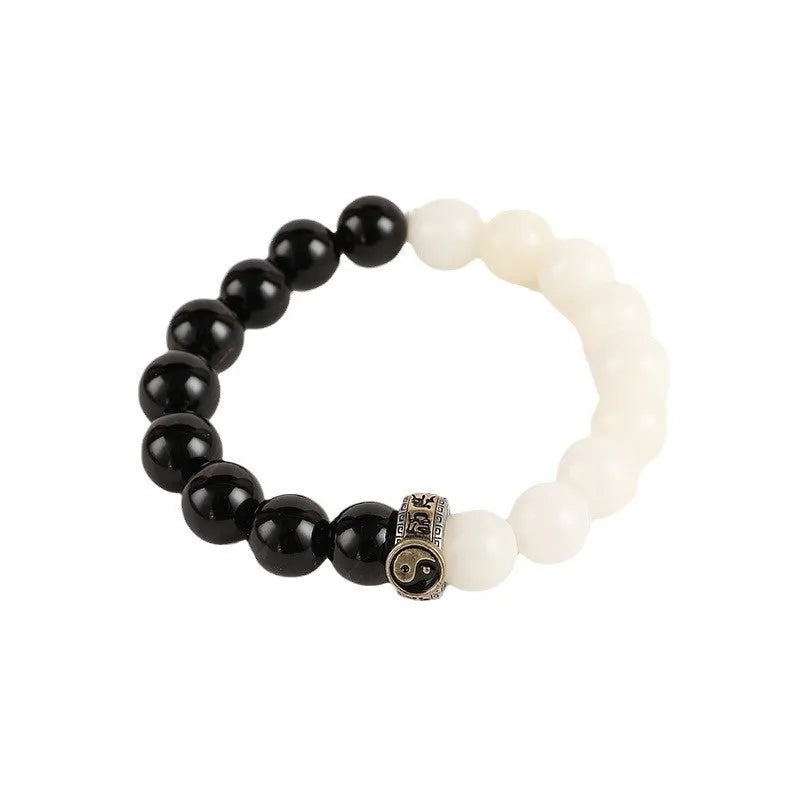 Black and white obsidian Taiji mantra bracelet with geometric beads and yin-yang symbol.