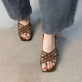 Retro-style women's high heel sandals with thin cross straps and an ankle buckle in light brown.