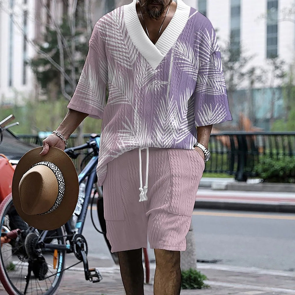 Man wearing a solid colour knitted short-sleeved top and matching shorts, showing the drop-shoulder design.