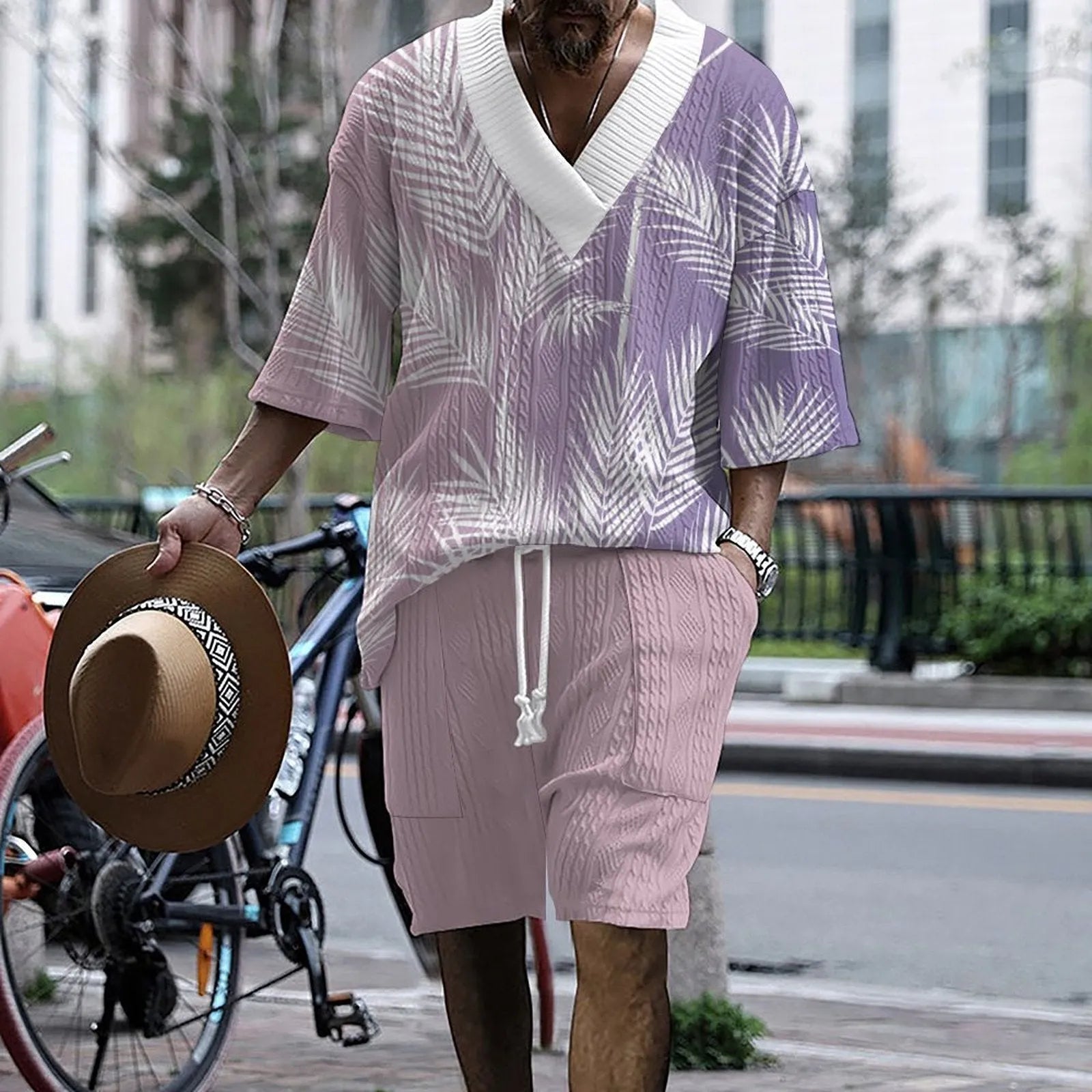 Man wearing a solid colour knitted short-sleeved top and matching shorts, showing the drop-shoulder design.