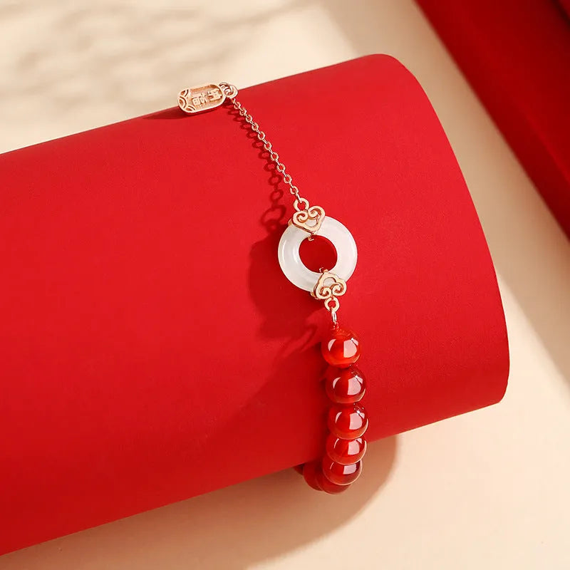 Close-up of a women's sterling silver bracelet with a peace buckle and engraved Chinese cloud and character motifs.
