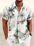 Man wearing a loose grey short sleeve shirt with a raised white 3D flower print pattern.