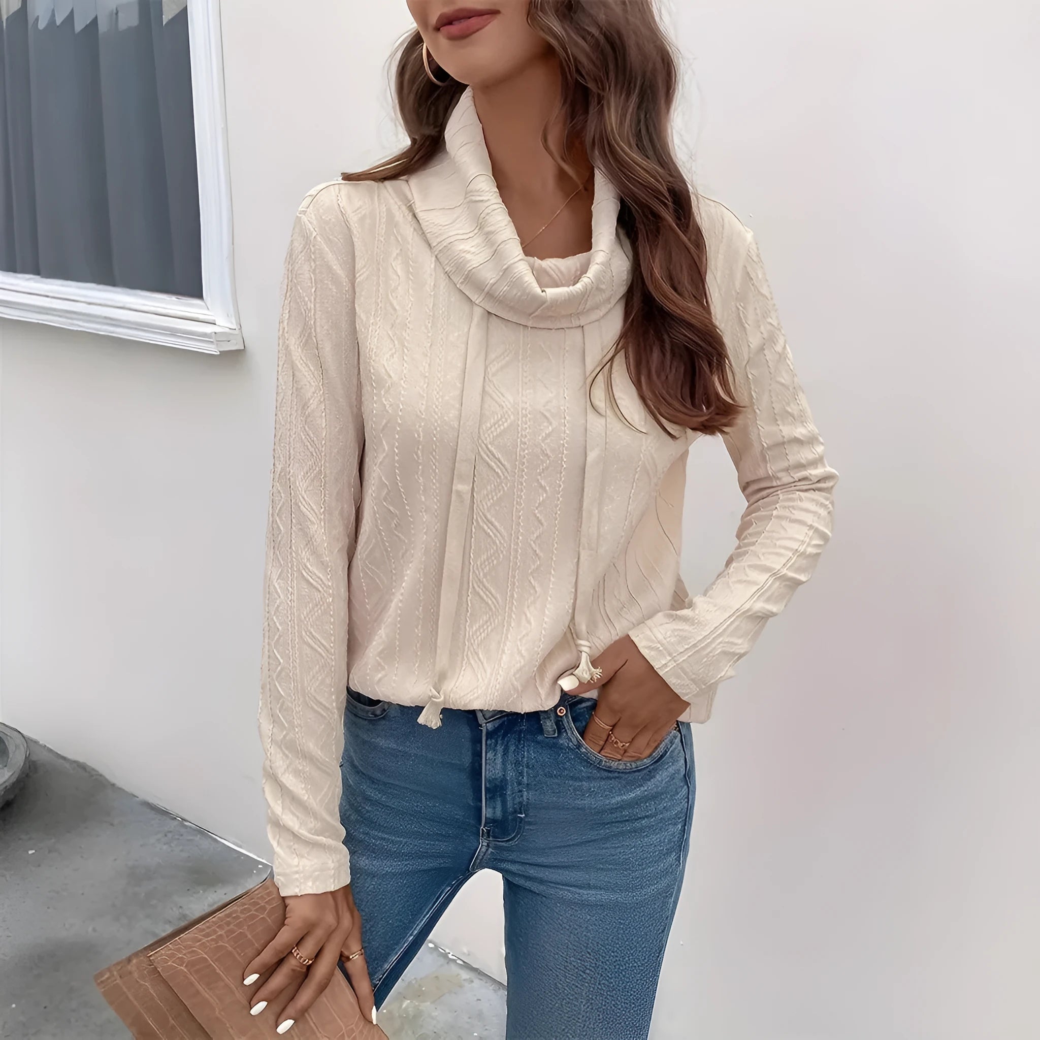 Apricot hooded pullover sweater with drawstring and long sleeves on hanger
