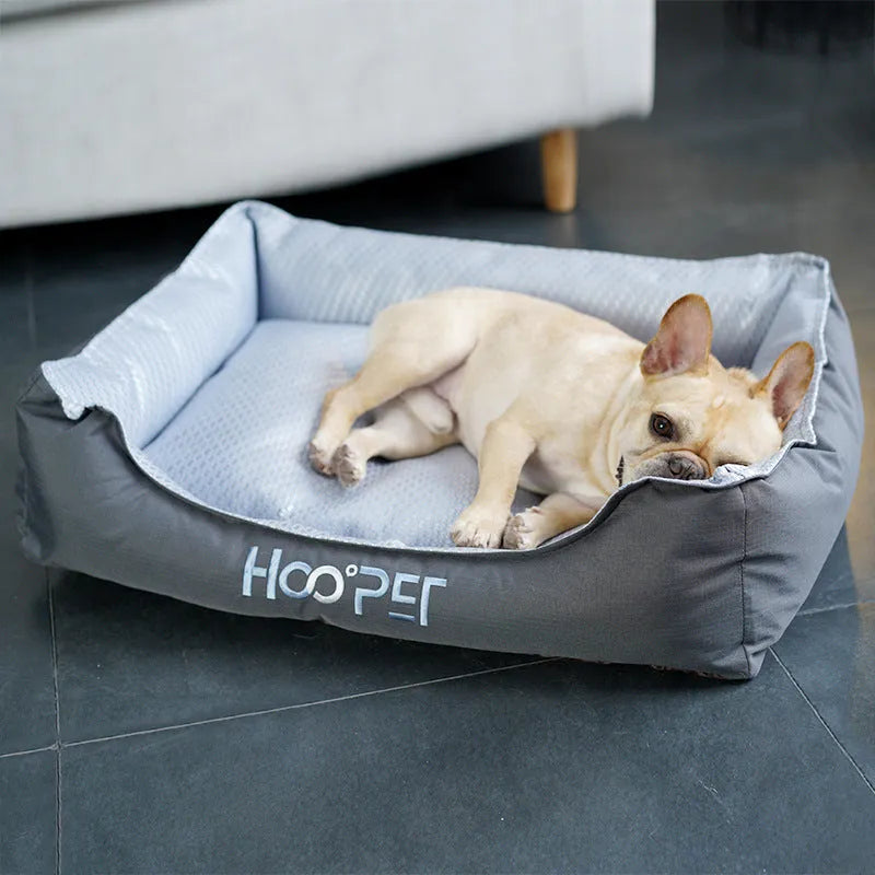 Soft grey dog bed with raised edges and a removable plush cover, shown in medium size.