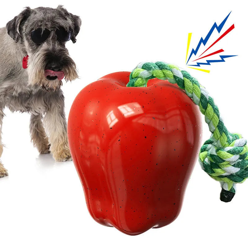 Green and red plastic apple-shaped dog chew toys for molar cleaning and outdoor play.