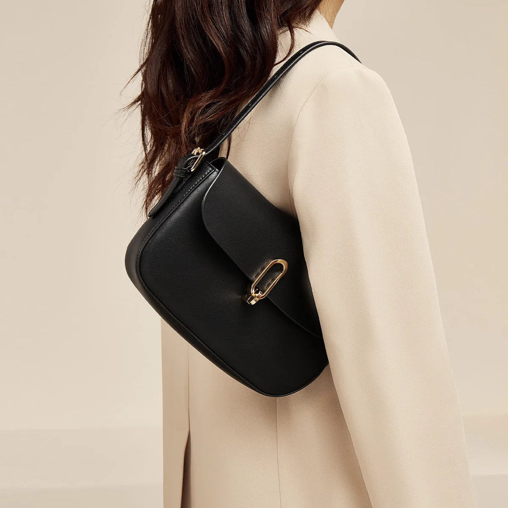 Square leather messenger bag in black with shoulder strap and lock fastener
