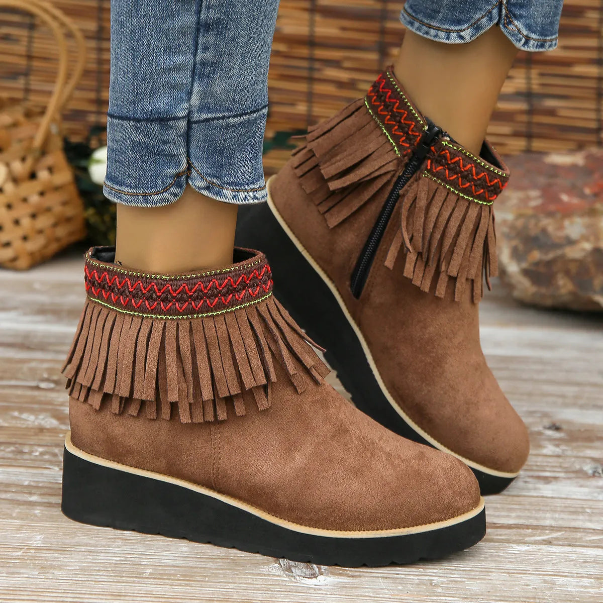 Women's black suede thick sole wedge ankle boots with side zip and tassel detail.